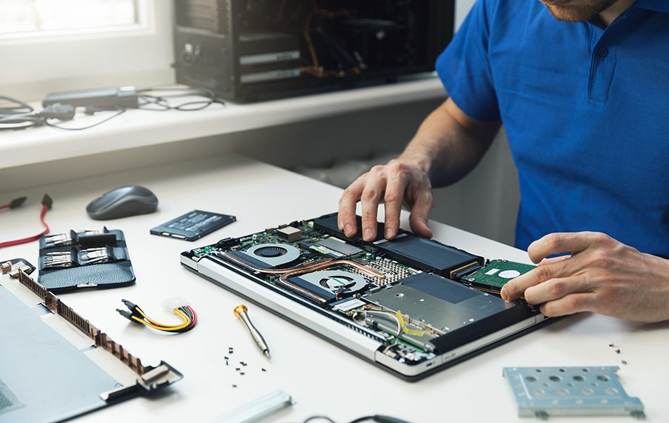computer repairman installing new hard disk drive in laptop | PC Systems Around You, LLC